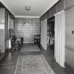 Interior. View of panelled hall from W showing entrance and archway to lounge