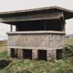 View from NE of the Battery Observation Post showing viewing platform, canopy and brick foundation pillars.