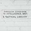 Tain Airfield Operation Block, detail of sign painted on wall 'Through corridor to Intelligence, Met. & Tactical Library'.