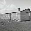Tain Airfield, No.4 dipersal area. Detail of accomodation huts of wooden construction, still in use.  These buildings are probably pre-war, being used as part of the original pre-war Bombing Range, view from SE.