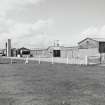 Tain Airfield, No.4 dispersal area.  Accomodation and transport buildings of wooden construction, originally part of the pre-war Bombing Range, still in use.  View from SE.