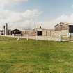 Tain Airfield, No.4 dispersal area.  Accomodation and transport buildings of wooden construction, originally part of the pre-war Bombing Range and still in use. View from SE.