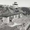 General view of site from S showing magazine, main World War II Battery Observation tower and entrance to the underground magazine with crane.