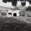 View of courtyard with cattle shelters from S