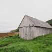 View of wooden boathouse from W