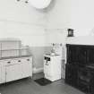 Interior. View of kitchen from South East showing bell board, dresser and range