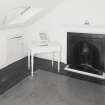 View of attic room showing fireplace
