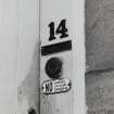 Front door, door plaques, number and bell, detail
