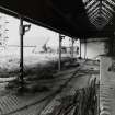 Whisky Bond.
General view of lean-to butted onto Warehouse no.5, showing railway sidings and cast-iron columns from South East.