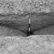 Excavation photograph: section of W ditch of riverside stores compound showing ditch filled and covered by gravel surface