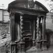 View of funerary monument on west wall of churchyard.