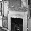 Interior, detail of fireplace in West wall of central apartment on First Floor.