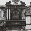 Detail of Byres monument in wall of churchyard.