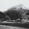 General view of Edinburgh Castle with Princes Street Gardens and Ross Fountain in foreground, inscr; 'Edinburgh Castle from Princes St. Gardens.', written on historic print mount is a poem, 'Here wealth still swells the Golden tide...'