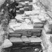 Excavation trench along base of church wall. Skeleton in situ.