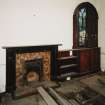 Inteior, ground floor, North East room, view of fireplace and bookcase.