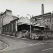 General view from North North East up Guthrie Street, showing tenement block at 18-24 Guthrie Street, and side of Cask Shed with loading bay filled in