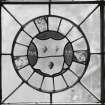 Detail of circular stained glass panel in South wall depicting the coat of arms of Mitchell Macquhane.