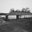 General view from NE of byre to NW of steading, with hipped roof and ventilators on ridge.