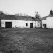 General view from NW across yard, showing granary with collapsing roof.