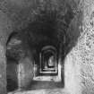 View from East along rear passage behind central block of kilns