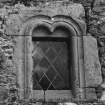 First floor window wth double arch head and  quirked roll and scallop mouldings on quoins, NW wall of stair turret