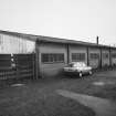 View of outbuilding from E.