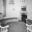 Interior.
View of main hall round tower with fitted seating and fireplace.