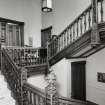 Interior view of the carved wooden staircase at mezzanine level seen from the North East.