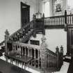 Interior view of the carved wooden staircase at first floor level seen from the South East.