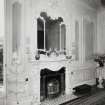 Interior view of the ornate fireplace and mirror on the West wall of the drawing room on the first floor.