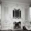 Interior view of the ornate fireplace and mirror on the South wall of the drawing room on the first floor.