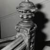 Interior detail of the carved newel post on the first floor staircase.