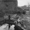 Detailed view from NW showing lade with sluice and main bypass (foreground), and mill and water-wheel house beyond