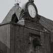 Athelstaneford Mains.
Detail of clock and bovine sculpture above main entrance in N side of steading, with wind vane in background.