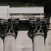 Detail of Corinthian capitals flanking central window.