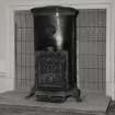 Interior.
Detail of chimneypiece and stove in dining room.