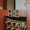 Interior.
Detail of decorative tiles in old kitchen on ground floor.