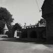 View of arched entrance to stable block from NW.