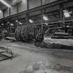 Interior.
View of ropery from SE of dismantled 'Disc-type' lock-coil rope closing/stranding machine (D11), moved from elsewhere in the factory (foundations in foreground mark position of site where it was to  be re-located).