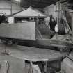 Interior.
View of ropery, 100-ton Test Range from W of winch house, with bogie turntable in foreground, and winch end of neighbouring 500-ton test range just visible to right. This view shows a bogie positioned on the turntable.