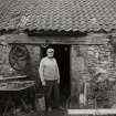 Smiddy, Emil Kozoki, blacksmith, at entrance doorway