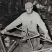 Smiddy, Emil Kozoki, blacksmith, at work on bending machine