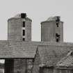 View from SW over pan-tile roofs towards concrete silage towers