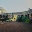 View of arcade flanking the entrance arch from W