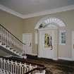 Interior. Ground floor View of entrance hall from NW showing staircase and front door