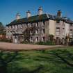 View from SW showing garden and entrance fronts.