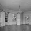 Interior. 
First floor drawing room, view from North showing bow window and arched niche with window, china shelves and fitted drop leaf table.
