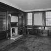 Interior. 
Second floor library at Northwest corner, view from East showing bookcases made from the woodwork of SS Columbia in 1934 and fireplace.