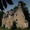View from SW showing blocked opening in the W gable of the 17th century house and 19th century addition.